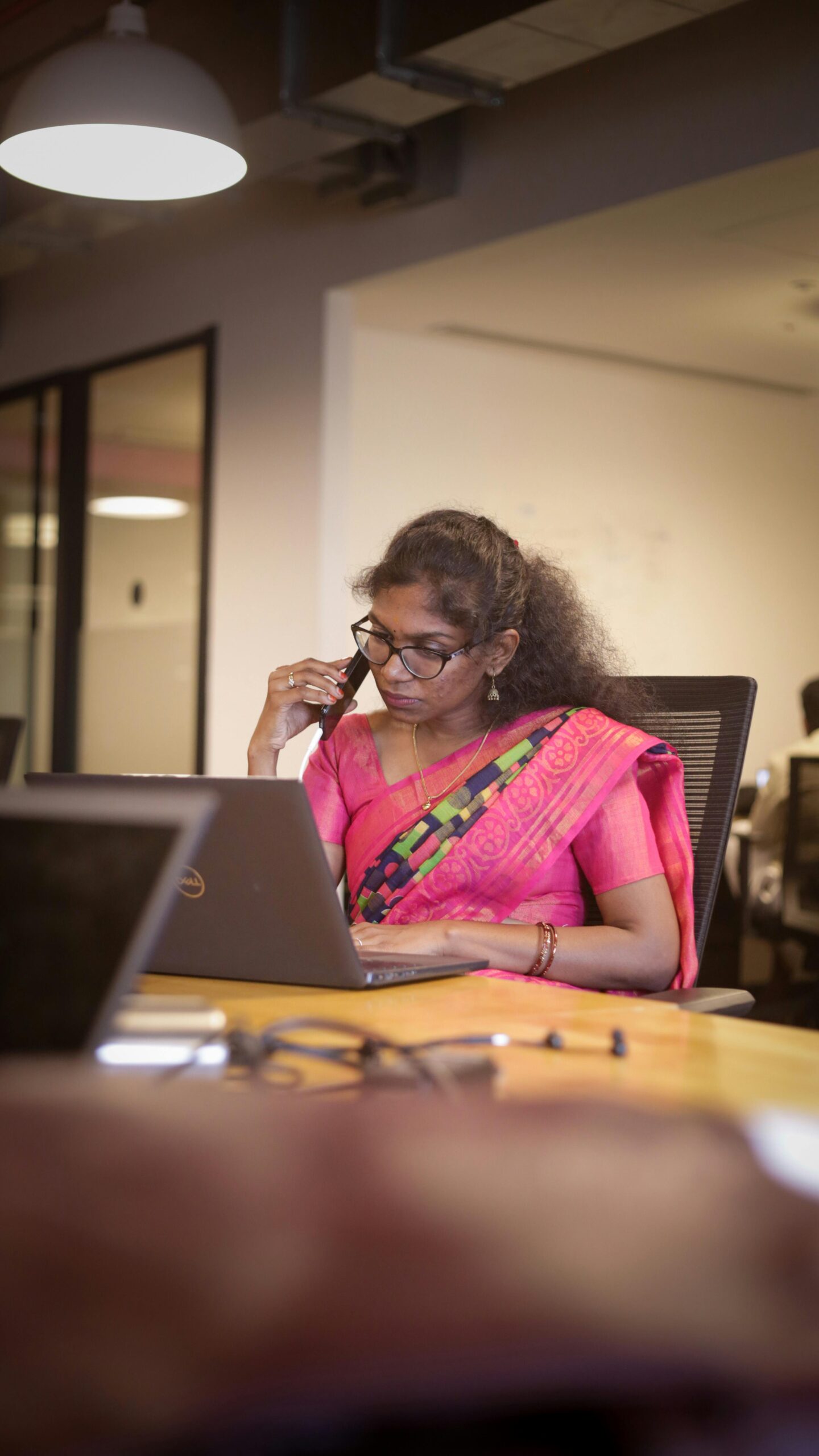 Indian In pink saree making phone call